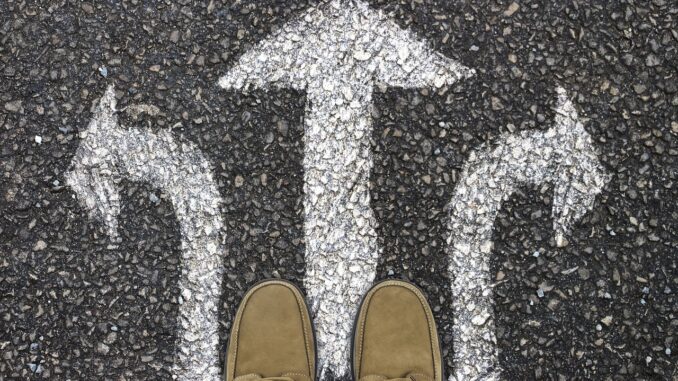 Arrows painted on pavement pointing in three directions, illustrating a lateral move with a legal recruiter