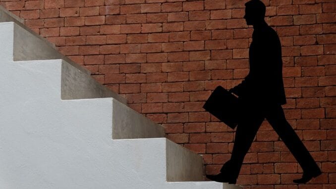 Businessman climbing stairs, illustrating cities with the most job opportunities