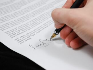 Professional services agreement on a desk with a pen