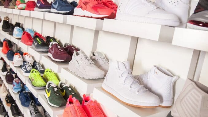 Sneakers on a store shelf, for an Authentic Brands chief legal officer hire Sneakers on a store shelf, for an Authentic Brands chief legal officer hire