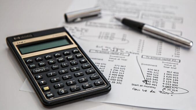Calculator on legal documents, tallying in-house lawyer fees
