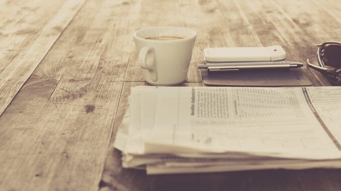 In-house counsel news briefing: a newspaper and a cup of coffee on a wooden table In-house counsel news briefing: a newspaper and a cup of coffee on a wooden table