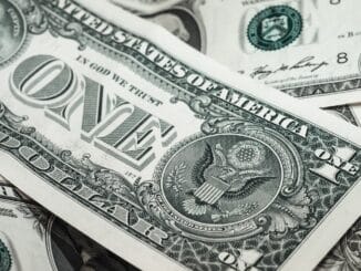 Close-up of US dollar bills: legal departments sending less outside counsel spend to law firms