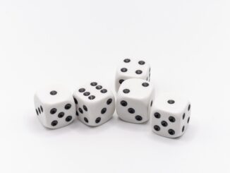 White dice on a white table, risk tolerance and chance