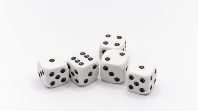 White dice on a white table, risk tolerance and chance