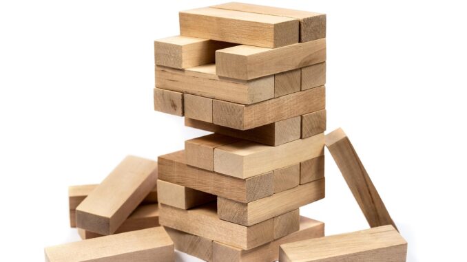 Wooden block tower collapsing, a Weil Gotshal law firm crisis concept